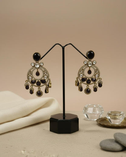ChicShukra gold‑tone imitation jewellery earrings with black and white stones on a black display stand