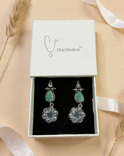 ChicShukra earrings in a box on a beige background