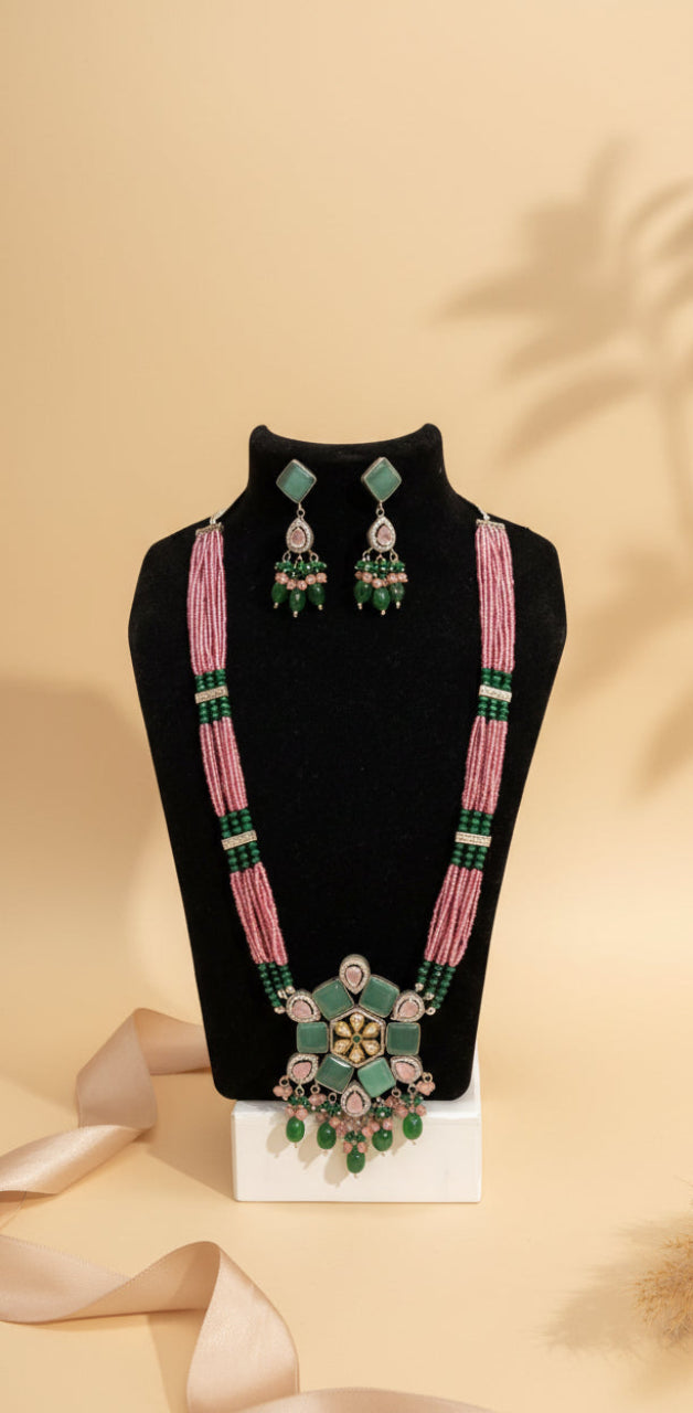 Pink and green beaded imitation jewellery necklace set with floral pendant and matching earrings from ChicShukra, displayed on a black mannequin.