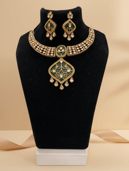 Chicshukra gold-toned imitation jewellery necklace set with green enamel pendant, kundan stones and matching earrings on black mannequin.