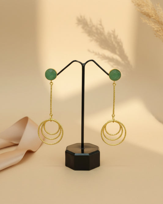 Elegant brass drop earrings featuring a round mint green stone stud and a dangling triple-layered textured gold-tone hoop design.