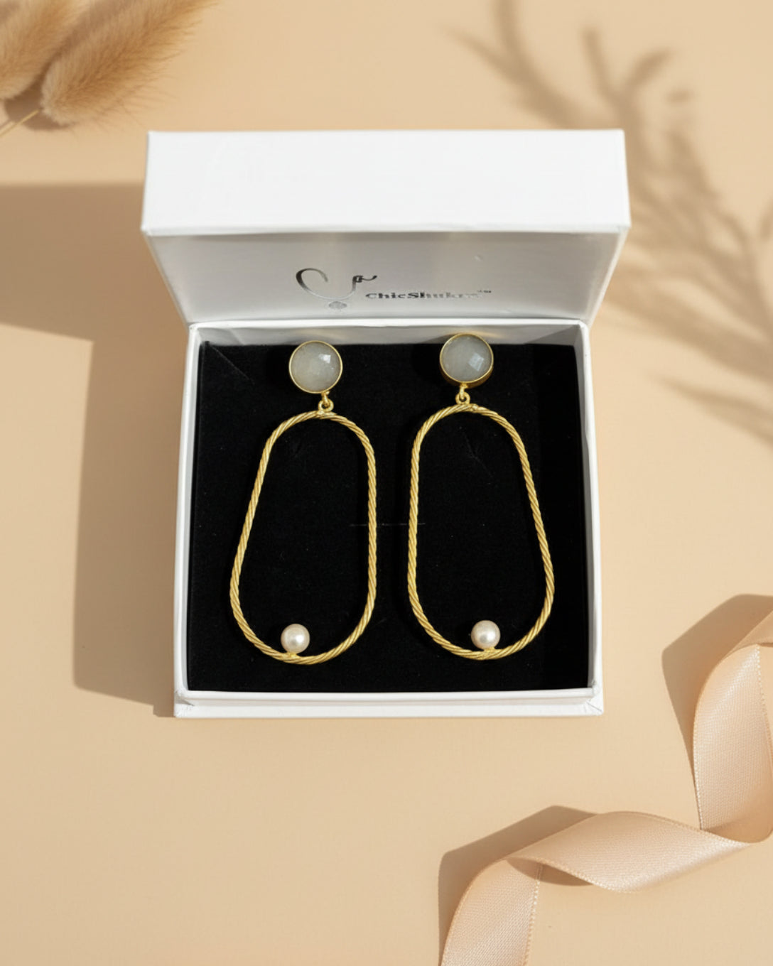 Gold earrings with pearls in a ChicShukra box