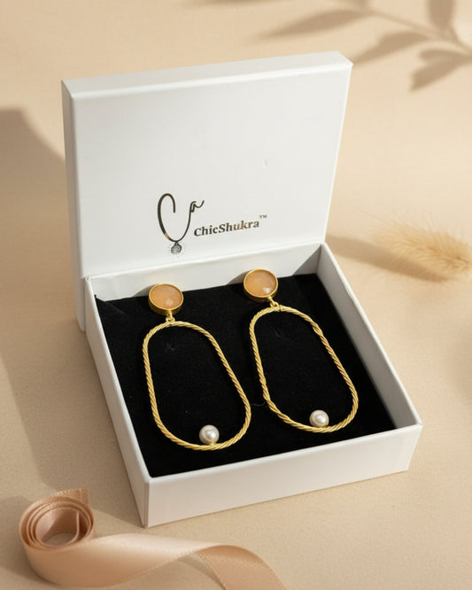 Gold hoop earrings with pearls on a ChicShukra branded box.