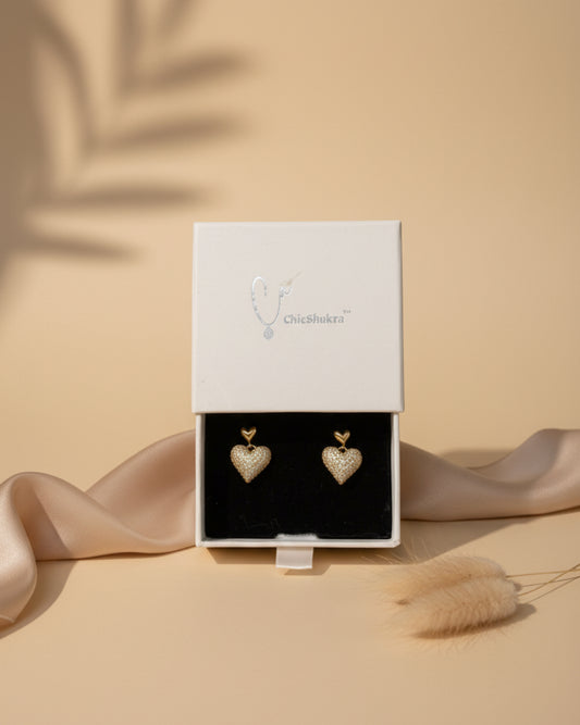 ChicShukra anti-tarnish 18k gold plated stud earrings featuring a dangling heart charm encrusted with brilliant micro-pave cubic zirconia stones.