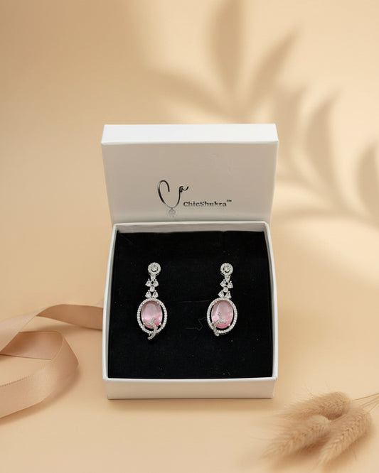 Pink earrings with silver detailing in a ChicShukra box