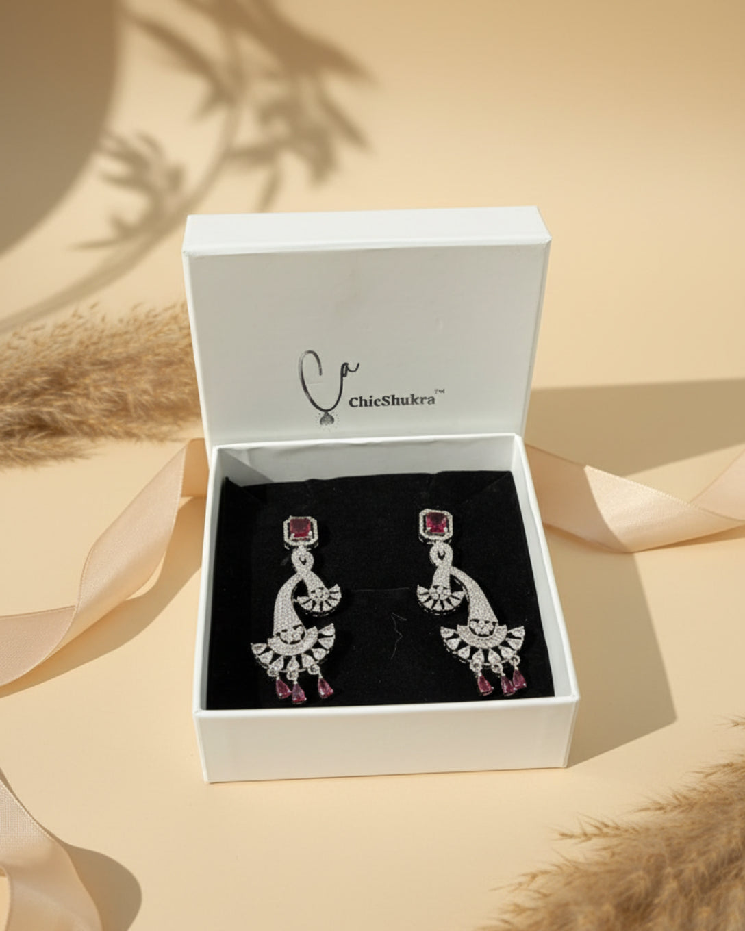 Silver earrings with red stones in a ChicShukra box